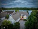 Scenic aerial view of a home near the lake, showcasing meticulous landscaping and waterfront access at 11137 Peppermill Ln, Fishers, IN 46037