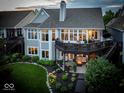 Stunning home exterior featuring a spacious deck, landscaped backyard, and outdoor fire pit at 11137 Peppermill Ln, Fishers, IN 46037
