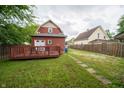 View of backyard featuring a wooden deck and a house that is adjacent to neighboring homes at 11218 Exchange St, Indianapolis, IN 46259