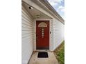 Inviting front door with wreath, security features, and sidelight, offering a warm welcome at 11620 Glenn Abbey Ln, Indianapolis, IN 46235