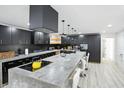 Modern kitchen with an island and black cabinetry, offering ample counter space and contemporary style at 1324 E 9Th, Indianapolis, IN 46202