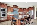 Gourmet kitchen with custom cabinets, stainless steel appliances, and a center island with bar seating at 14737 Macduff Dr, Noblesville, IN 46062
