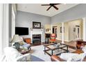 Spacious living room with a fireplace, tall ceilings, large windows, and comfortable seating at 14737 Macduff Dr, Noblesville, IN 46062