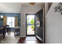 Warm entryway with hardwood floors, leading to a dining area with a charming dog crate under the table at 15372 Black Gold Ct, Noblesville, IN 46060