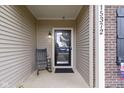 Inviting front porch with rocking chair, accent lighting, and welcoming decor to greet guests at 15372 Black Gold Ct, Noblesville, IN 46060