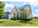 Charming two-story home with a well-kept lawn, lush landscaping, and a two-car garage at 15984 Conductors Dr, Westfield, IN 46074