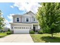 Traditional home featuring stone accents, a two-car garage, and a professionally landscaped front yard at 15984 Conductors Dr, Westfield, IN 46074