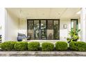 Inviting front porch with hanging swing, privacy shrubs, and sliding glass doors at 1610 N Alabama St, Indianapolis, IN 46202