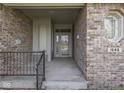 Inviting front porch with brick accents, a wrought-iron railing, and clear home address at 1645 Oakmere Way, Greenwood, IN 46142