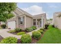 Beautiful home showcasing manicured landscaping, brick accents, and a welcoming front entrance at 16573 Grappa Trl, Fishers, IN 46037