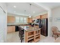 Bright kitchen with center island, stainless steel appliances, and ample cabinet space at 16573 Grappa Trl, Fishers, IN 46037