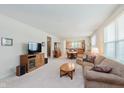 Inviting living room featuring neutral tones, plush carpeting, and abundant natural light at 16573 Grappa Trl, Fishers, IN 46037