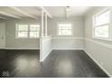 Open-concept living space features hardwood floors, decorative columns, and large windows for ample natural light at 2035 W Kessler Blvd N Dr, Indianapolis, IN 46222