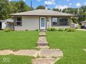 Charming single-story home with a well-maintained lawn and inviting front entrance at 320 Sunset Dr, Shelbyville, IN 46176
