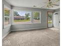 Bright living room featuring large windows and plush carpeting at 320 Sunset Dr, Shelbyville, IN 46176