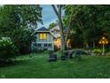 A tranquil backyard with a lush lawn, patio seating, and a beautiful home exterior at 4130 N Meridian St, Indianapolis, IN 46208