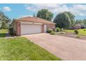 Spacious two-car garage with a paved driveway and mature landscaping at 425 Saddle Hill Ct, Indianapolis, IN 46234