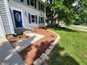 Close-up of a home's entry way showing the stone pathway and landscaping at 4536 Clayburn Dr, Indianapolis, IN 46268