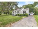 Quaint home exterior showcasing a well-manicured lawn and a detached garage with a driveway at 5315 Rosslyn Ave, Indianapolis, IN 46220