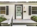 Close-up of the inviting front porch with a dark trim and gray painted steps and porch at 5315 Rosslyn Ave, Indianapolis, IN 46220