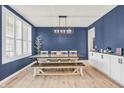 Elegant dining room with a modern chandelier, large window with shutter, and a cozy setting for Gathering gatherings at 5353 Hibiscus Dr, Plainfield, IN 46168