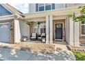 Inviting front porch with seating, decorative columns, and a welcoming entrance for relaxing and enjoying the outdoors at 5353 Hibiscus Dr, Plainfield, IN 46168