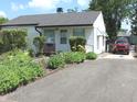 Ranch style home with a driveway and mature landscaping for added privacy at 5409 E 19Th St, Indianapolis, IN 46218