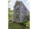Two-story home with gray siding, white trim, and mature landscaping at 630 Dorman St, Indianapolis, IN 46202