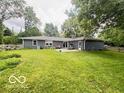 Large fenced backyard offers plenty of space for outdoor entertaining and recreation at 6546 Derbyshire Rd, Indianapolis, IN 46227
