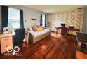 Spacious bedroom with hardwood floors, ample natural light, and a versatile layout with office space at 6546 Derbyshire Rd, Indianapolis, IN 46227