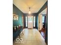 Inviting home foyer featuring tile flooring, elegant lighting, and a view into an adjacent office area at 6546 Derbyshire Rd, Indianapolis, IN 46227
