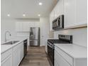 Stylish kitchen features stainless appliances, white subway tile and sleek black gas range at 7282 Shroyer Way, Noblesville, IN 46062