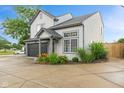 Charming home with neutral siding, a dark garage door, and lovely landscaping at 772 Cembra Dr, Greenwood, IN 46143