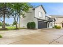 Charming home with neutral siding, a dark garage door, and a spacious yard at 772 Cembra Dr, Greenwood, IN 46143