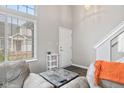Bright living room with soaring windows, hardwood floors and neutral paint at 772 Cembra Dr, Greenwood, IN 46143