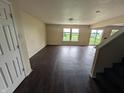 Spacious living room featuring wood floors, neutral walls, and access to the backyard at 908 Belvedere Dr, Shelbyville, IN 46176