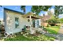 Charming home with a covered porch and well-maintained front yard at 909 Pearl St, Columbus, IN 47201