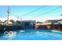 Backyard in-ground pool next to a modern outbuilding, with partial fencing at 909 Pearl St, Columbus, IN 47201