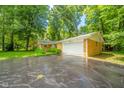 View of the house and long driveway leading to attached two-car garage at 10104 Sycamore Ln, Indianapolis, IN 46239