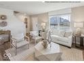 Bright living room with large windows, neutral tones, and stylish decor including a unique geometric coffee table at 1334 Aster Dr, Shelbyville, IN 46176