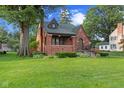 Charming brick home with a well-manicured lawn and inviting front porch at 1420 E Loretta Dr, Indianapolis, IN 46227