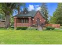 Charming brick home with a well-manicured lawn and inviting front porch at 1420 E Loretta Dr, Indianapolis, IN 46227