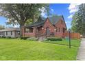 Charming brick home with a well-manicured lawn and inviting front porch at 1420 E Loretta Dr, Indianapolis, IN 46227