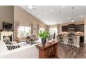 Open-concept living space with kitchen, dining area, fireplace, and large windows at 2057 Abbey Ln, Columbus, IN 47201