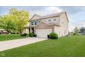 Side view of a lovely 2 story home with a well-maintained lawn at 20846 Winding Lake E Dr, Noblesville, IN 46062