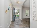 Inviting foyer with gray walls, wood flooring, and an open doorway at 20846 Winding Lake E Dr, Noblesville, IN 46062