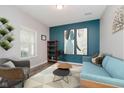 Comfortable living room with modern decor, stylish seating, and bright accent wall at 20846 Winding Lake E Dr, Noblesville, IN 46062