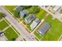 Aerial view of a charming home with spacious lot outlined in red, showcasing the property's boundaries and surroundings at 2111 Central Ave, Anderson, IN 46016