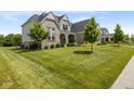 Lovely two-story home with manicured lawn and a classic architectural design at 2566 Maple Creek Dr, Westfield, IN 46074