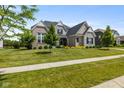 Beautiful two-story home with a well-manicured lawn and classic architectural details at 2566 Maple Creek Dr, Westfield, IN 46074